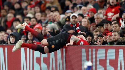 Manchester United's Phil Jones collides with the advertisement board during the match. Reuters