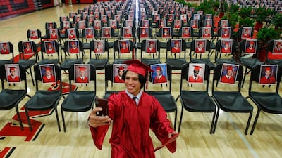 Paul Santiago Kelley, a graduating senior at Brophy College Preparatory, smiles as he takes a selfie as he celebrates Diploma Days with photos of all his fellow classmates in Phoenix, Arizona, USA. AP Photo