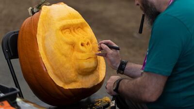 A man carves a gorilla's face into a pumpkin at the All Carved Out stand. This year's Chelsea Flower Show was delayed from its usual spring dates due to the Covid-19 pandemic, which also prompted its cancellation last year. Getty Images