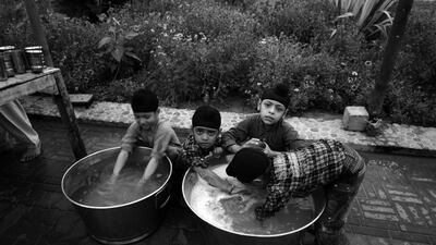 Sikh children in Nankana Sahib, Punjab washing utensils after 'langar', a free meal distributed to visitors in Sikh temples. Mobeen Ansari