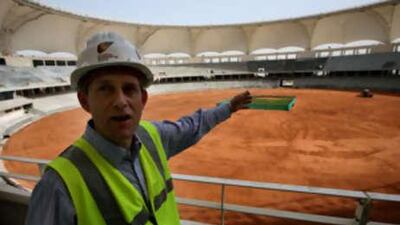 Malcolm Thorpe, of Dubai Sports City, points to the main cricket stadium that can accommodate 25,000 people during a tour of Dubai Sports city.