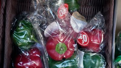 Peppers wrapped in plastic in a grocery stall in Paris before a French government ban on such packaging went into effect on January 1, 2022. AP Photo