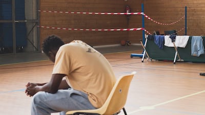 Kaba, 15, from Guinea, sits in a sports centre in the south of Paris, where young homeless people are living. Orysia Murat for The National