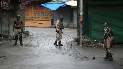 Indian paramilitary soldiers close a street using barbwire in Srinagar, Indian controlled Kashmir, Saturday, Aug. 10, 2019. AP