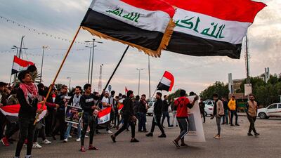 Protesters march with national flags during an anti-government demonstration, also calling for freedom of the press, in the southern Iraqi city of Basra. AFP