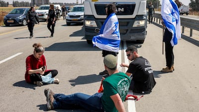 Israeli protesters block the road to Jordanian lorries carrying humanitarian aid in southern Israel on April 16. That such disruptive actions are allowed to repeatedly take place shows the impunity enjoyed by some right-wing groups in Israel. AFP