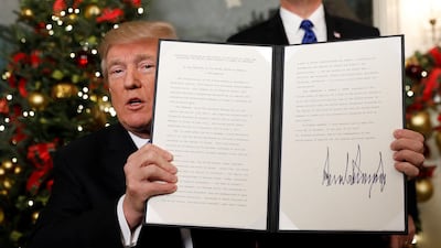 US president Donald Trump holds up the proclamation announcing that the United States recognises Jerusalem as the capital of Israel and will begin the process of moving its embassy there, during an address from the White House in Washington on December 6, 2017. Kevin Lamarque / Reuters