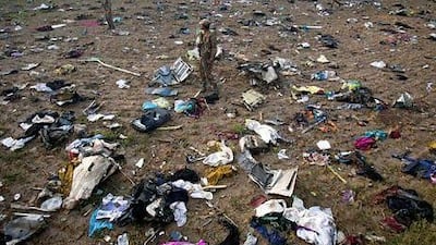 A Pakistan soldier on Saturday stands amid the debris of the Boeing 737 passenger plane that crashed near Islamabad.