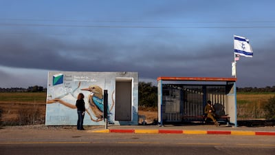 Tali Kizhner looks at a mural painted on the bomb shelter in which her son sought refuge before he was killed during the October 7, 2023 Hamas-led attacks in Israel. Reuters