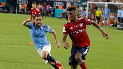 Bayern Munich's Kingsley Coman holds off Manchester City Bernardo Silva. EPA