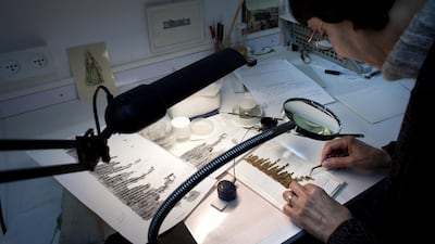 A conservation analyst from the Israeli Antiquities department examines fragments of the 2000-year-old Dead Sea scrolls. Getty Images