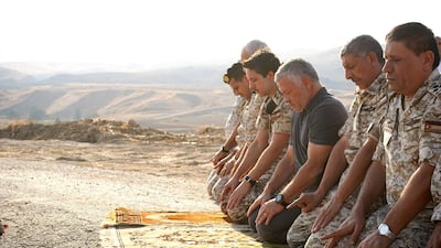 King Abdullah II of Jordan (centre) and his son, Crown Prince Hussein (second left), next to him, praying with army officers during a ceremony at the Jordan Valley site of Baqura, east of the Jordan River, one day after a deal dating from the historic 1994 peace treaty between the desert kingdom and Israel allowing Israeli farmers to lease two sites along their common border ran out. AFP