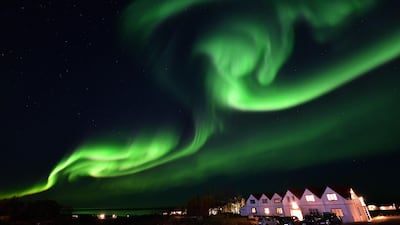 The aurora borealis, also known as northern lights, illuminates the sky in Iceland. The cost of happiness in the country is $107,351 annually. Photo: AFP