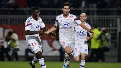 Lyon midfielder Yoann Gourcuff, centre, celebrates with his teammates after scoring the winner in Lyon's 1-0 victory over Marseille on Sunday in Ligue 1. Jeff Pachoud / AFP / October 26, 2014