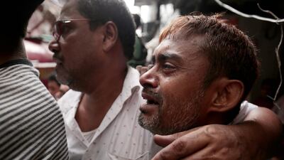 Shop owners show their anguish as their businesses go up in flames. EPA