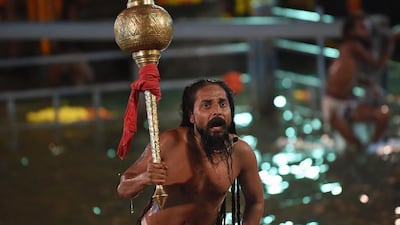 An Indian Hindu holy man reacts after his first holy dip at the Kumbh Mela. AFP