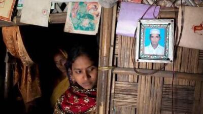 At right, a picture of Mohammed Bohran Uddin, one of the men who died last week in the bus crash, hangs on the wall of his parents' home in Anwara, south-east of Chittagong. Silvia Razgova / The National