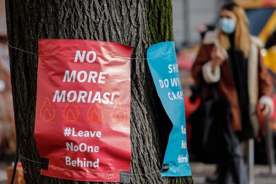 Posters calling for "No more Morias", referring to the Moria refugee camp on the Greek island of Lesbos which burned down, are hung on a tree on February 18, 2021 in Berlin's Kreuzberg district. AFP