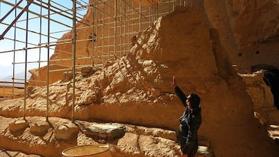 Afghan archaeological guard, Hakim Safam, stands in front of the reconstructed foot of the Salsal Buddha, on November 6, 2016, in Bamiyan province. The statue was about 55 metres high before being destroyed in 2001 by the Taliban. Agence France-Presse
