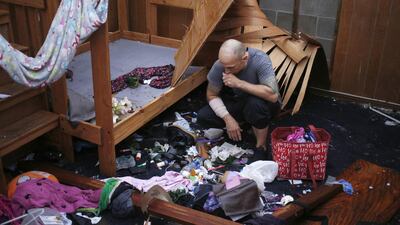 A resident looks at belongs scattered on a floor at a damaged home after Hurricane Michael hit in Panama City, Florida. Bloomberg