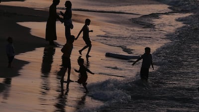 Palestinians on the beach at sunset, west of Gaza city. EPA