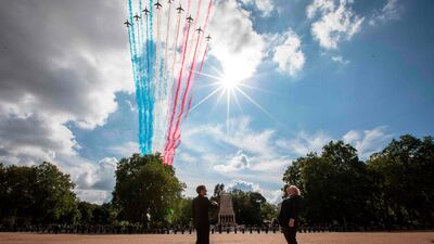 French President Emmanuel Macron, left, and Britain's Prime Minister Boris Johnson watch as The Royal Air Force Aerobatic Team, the Red Arrows, and the French Air Force Aerobatic Team, La Patrouille de France, perform a fly-past from Horse Guards Parade in London during a visit to commemorate the 80th anniversary of former French president Charles de Gaulle's appeal to French people to resist the Nazi occupation during World War II. AFP