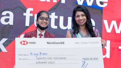 Sreya Binesh accepts her prize from Sabrin Rahman