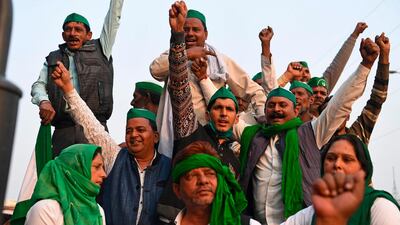 Farmers shout slogans near a police road block stopping them from marching to New Delhi to protest against the central government's recent agricultural reforms. AFP