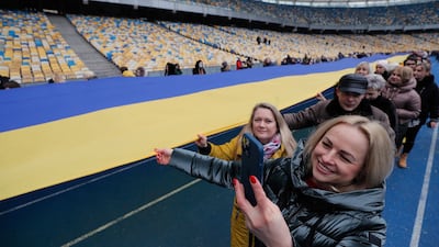 Ukrainians carry the flag around Olimpiyskiy stadium in Kiev. EPA