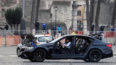 Tom Cruise, left, with British actress Hayley Atwell, right, in a car during the shooting of 'Mission: Impossible 7' at Piazza Venezia in Rome, Italy on November 29, 2020. EPA