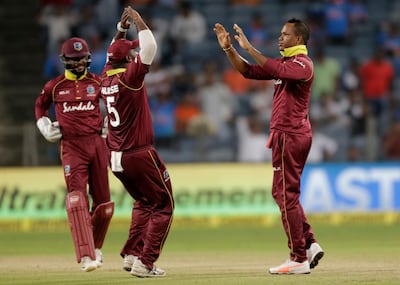 West Indies' batting all-rounder Marlon Samuels, right, took three wickets for just 12 runs against India. AP Photo