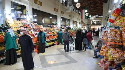 Customers shop at fruit stalls at Souk Al Mubarakiya in Kuwait City. Kuwait's government has cancelled National Day and Liberation Day celebrations on February 25 and 26, due to the Covid-19 pandemic. EPA