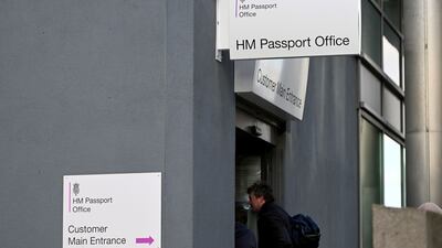 Members of the public wait outside the entrance to the Passport Office in Liverpool as Public and Commercial Services Union members stage a strike. Bloomberg