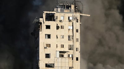 Smoke engulfs a building destroyed by Israeli air strikes amid a flare-up of Israeli-Palestinian violence in Gaza city. Reuters