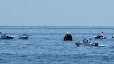 Support teams and recreational boaters arriving at the SpaceX Crew Dragon Endeavour spacecraft shortly after it landed. EPA