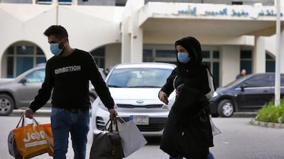 People wear face masks outside of the Rafik Hariri University Hospital where a woman is treated for coronavirus, the first case in Beirut, Lebanon. EPA