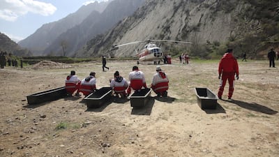 In this photo provided by the Iranian Labor News Agency, ILNA, rescue workers wait for the bodies of passengers from a Turkish private jet that crashed on Sunday in the Zagros Mountains, outside of the city of Shahr-e Kord, outside of the city of Shahr-e Kord, some 370 kilometers, or 230 miles, south of the capital, Tehran, Iran, Monday, March 12, 2018. Investigators on Monday found the "black box" from the jet that crashed on its way from the United Arab Emirates to Istanbul, killing all 11 people on board, including a Turkish bride-to-be and her bachelorette party. (Mostafa Safari/ILNA, via AP)