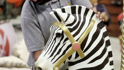 A staff members at The Prop Shop works on a carousel zebra. Chris Whiteoak / The National