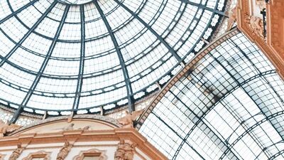 Tourists wearing protective facemasks visit the Gallery Vittorio Emanuele II, in Milan, Italy. AFP