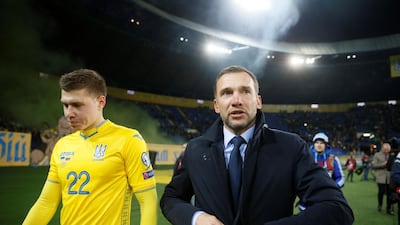 Ukraine's Mykola Matvyenko and coach Andriy Shevchenko celebrate at the end of the match. Reuters