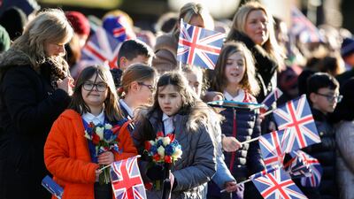 Children wait with flowers outside Bolton Town Hall. Reuters