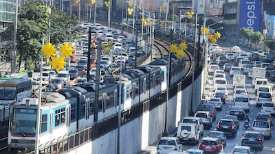 A major thoroughfare in Manila is clogged with traffic as an overhead train passes by. Jay Directo / AFP Photo