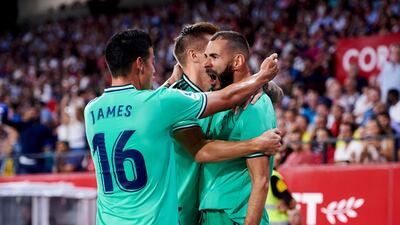 Karim Benzema of Real Madrid celebrates with his teammate Toni Kroos and James Rodriguez. Getty Images