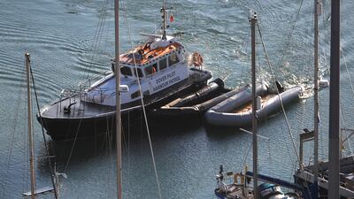 Inflatable boats used by migrants who crossed the English Channel are moved to a marina in Dover, England. Photo: Reuters