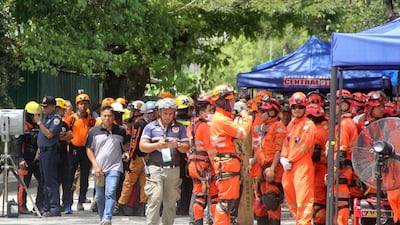 epa07961972 Filipino rescuers gather in front of a damaged residential building in the aftermath of a 6.5 magnitude earthquake, in Davao city, Philippines, 31 October 2019.'According to the United States Geological Survey (USGS), a 6.5 magnitude earthquake occurred at a depth of 10km near Bulatukan, Cotabato province, on 31 October. It is the third strong earthquake the area has experienced this month. EPA/MIKE S. MARIANO