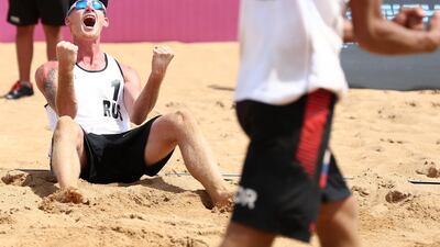 Maxim Sivolap and Igor Velichko of Russia celebrate their win at the FIVB Beach Volleyball World Tour Qinzhou Open in China. Zhong Zhi / Getty Images