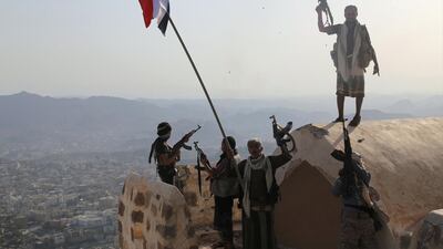 Fighters loyal to Yemeni President Abdrabu Mansur Hadi stand on top of the Al Qahira Castle, located on the highest mountain in the third city of Taez after they seized it from rebel fighters. AFP