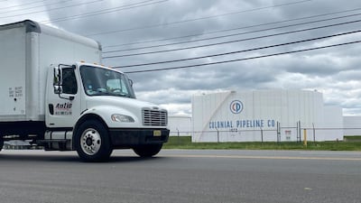 A truck passes holding tanks at Colonial Pipeline's Linden Junction Tank Farm in Woodbridge, New Jersey. The US government issued emergency laws to allow for fuel to be transported by road. Reuters