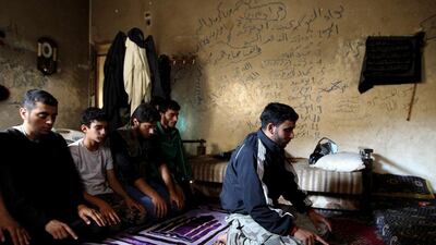 Members of a rebel group called the Martyr Al-Abbas pray in a safe house in Aleppo. The group consists of five brothers and other members and operate under the FSA. Muzaffar Salman / Reuters