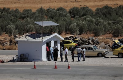 A group of civilians at a checkpoint in Sawara Sughra, in Sweida province. Reuters